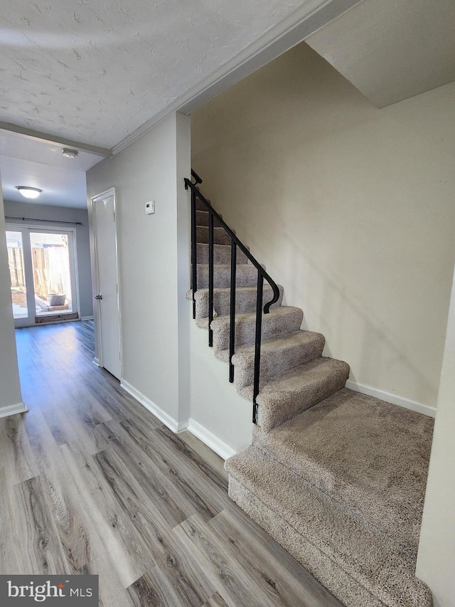 stairway featuring hardwood / wood-style floors