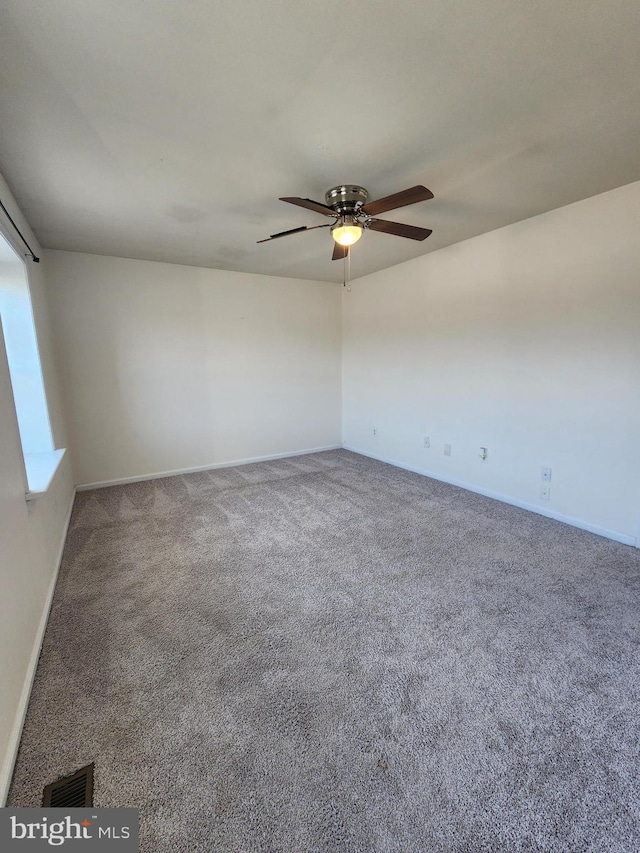 unfurnished room with ceiling fan and carpet flooring