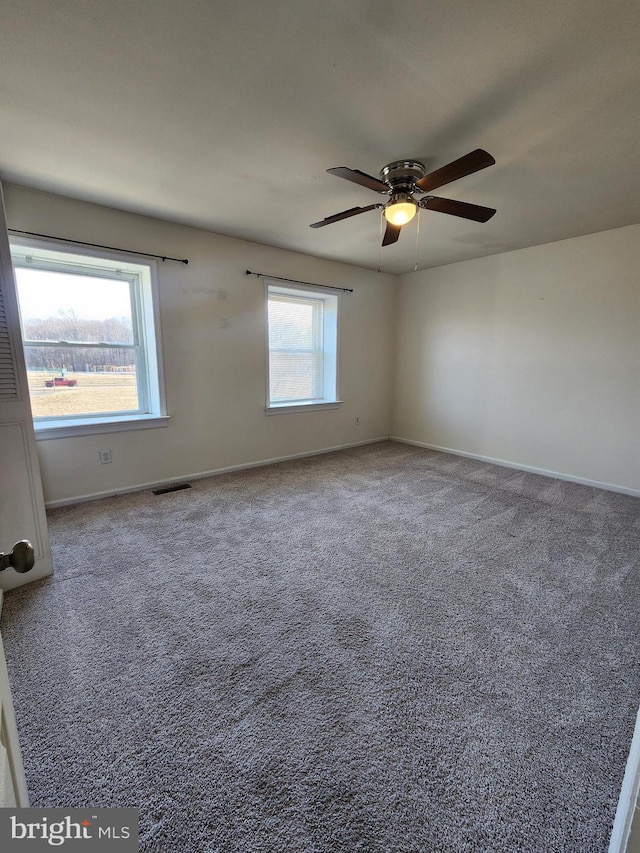 carpeted empty room featuring ceiling fan