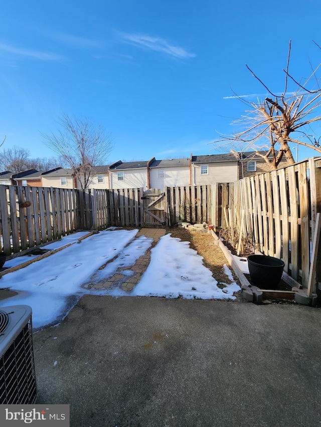 yard covered in snow with central AC unit