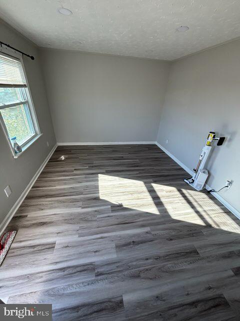 spare room with hardwood / wood-style flooring and a textured ceiling