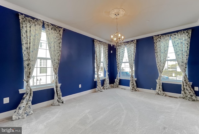 carpeted empty room with an inviting chandelier and ornamental molding