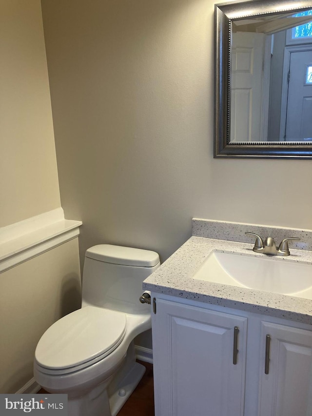 bathroom featuring toilet and vanity