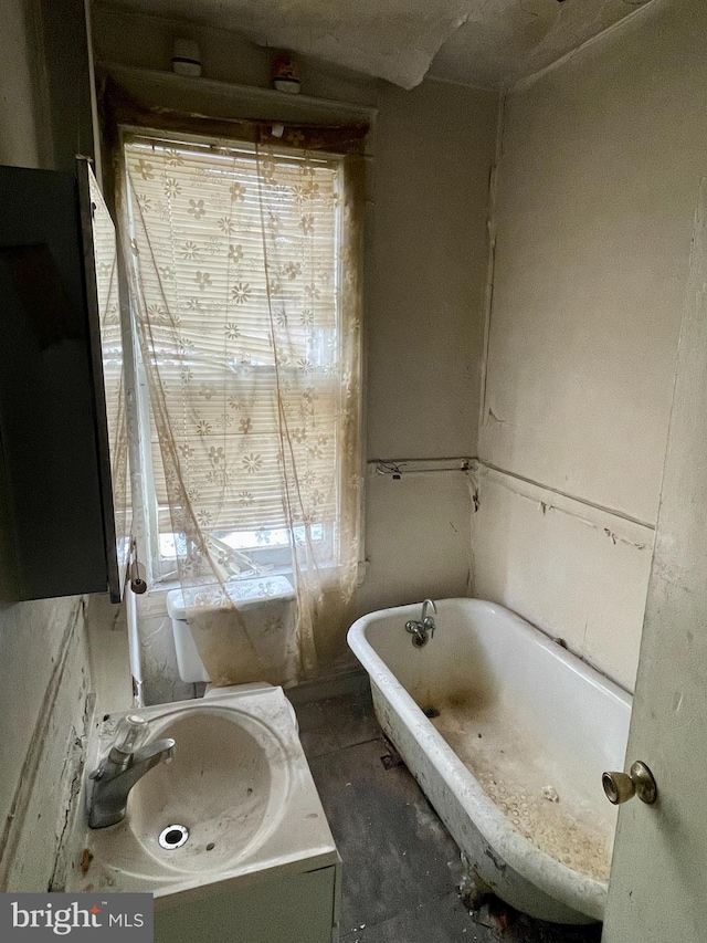 bathroom with a washtub and sink