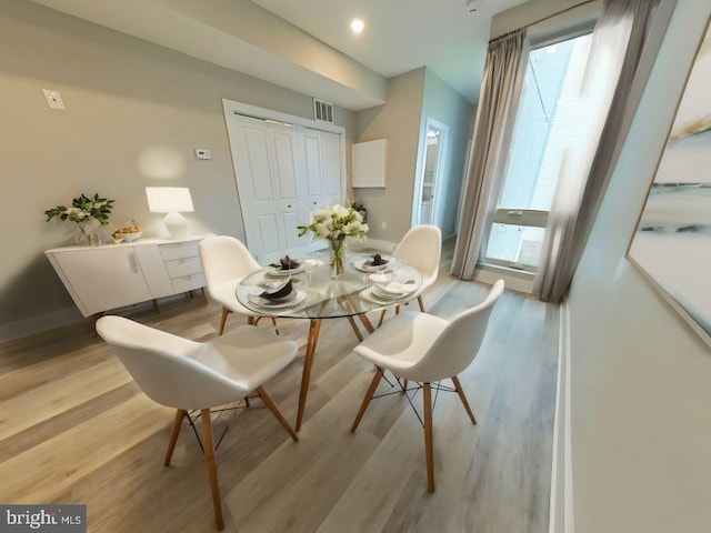 dining space with light hardwood / wood-style floors