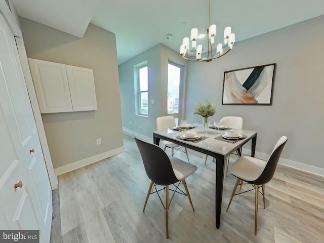 dining area featuring a chandelier and light hardwood / wood-style floors