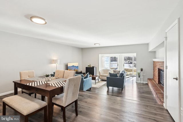 dining room with a fireplace and dark hardwood / wood-style floors