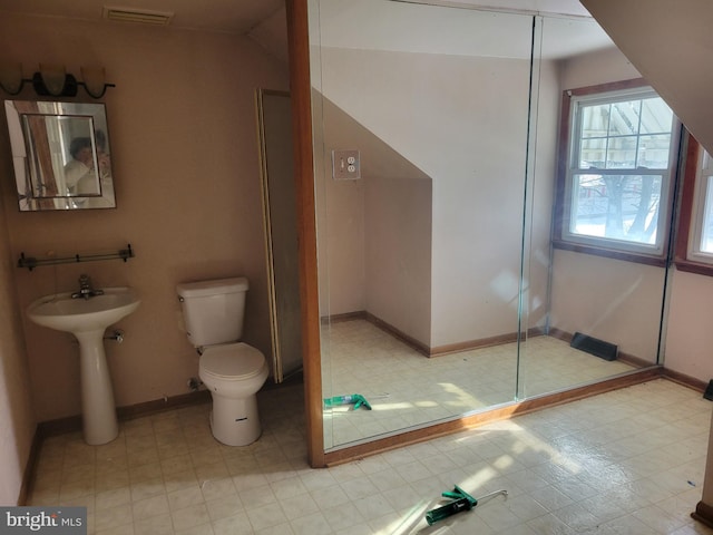 bathroom with sink, toilet, and walk in shower