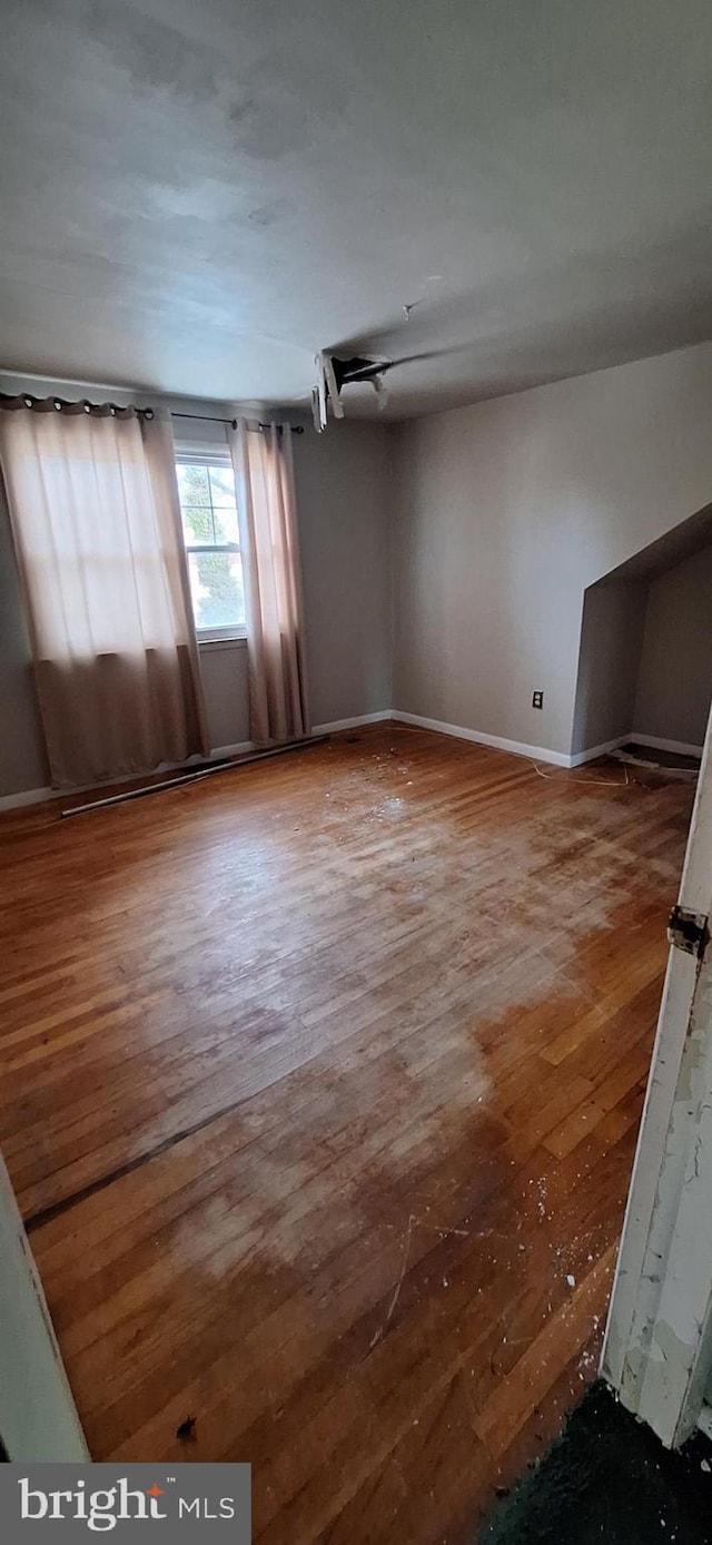 empty room with hardwood / wood-style flooring