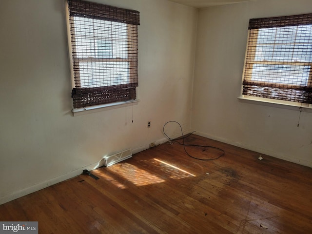 unfurnished room with hardwood / wood-style flooring