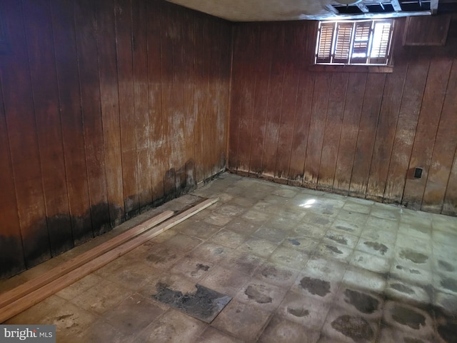 basement featuring wood walls