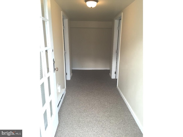 corridor featuring a baseboard radiator and carpet