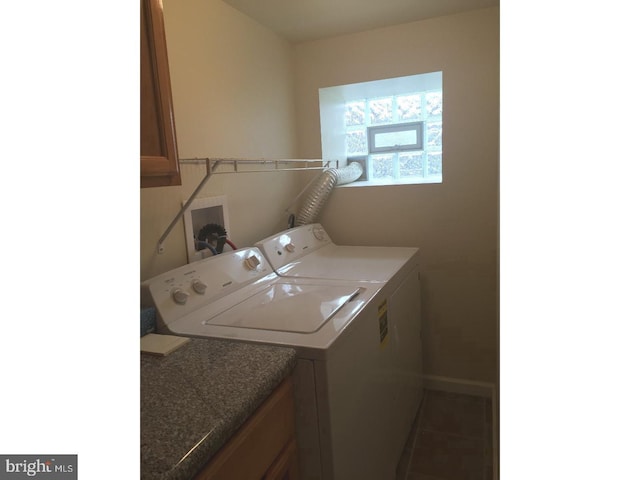 washroom with cabinets, washing machine and clothes dryer, and tile patterned flooring