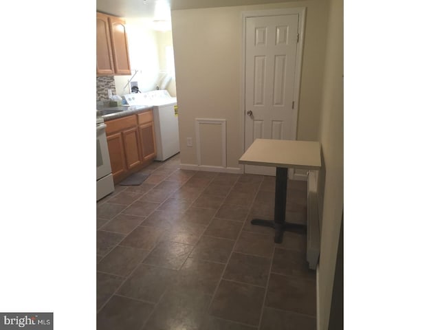 interior space with washer / dryer and backsplash