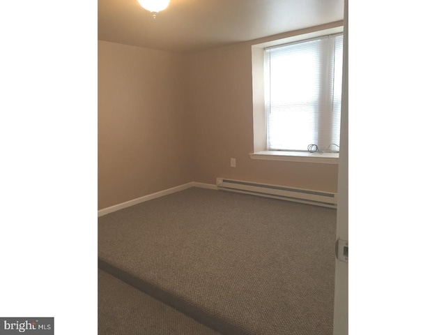 unfurnished room featuring carpet and baseboard heating