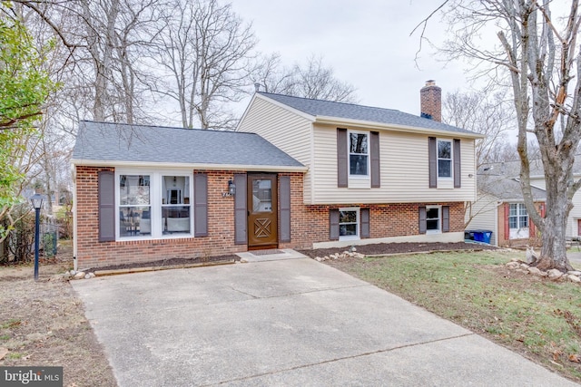 tri-level home with a front lawn