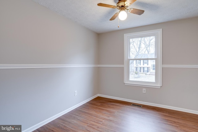 unfurnished room with hardwood / wood-style flooring, ceiling fan, and a textured ceiling