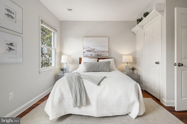 bedroom with dark wood-type flooring