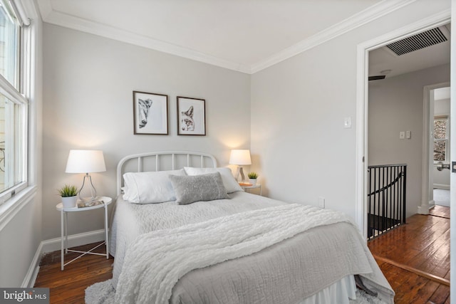 bedroom featuring ornamental molding and dark hardwood / wood-style floors