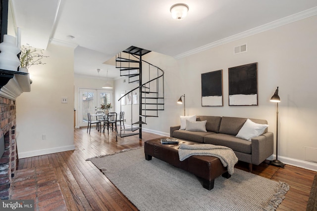 living room featuring crown molding, a fireplace, and dark hardwood / wood-style floors