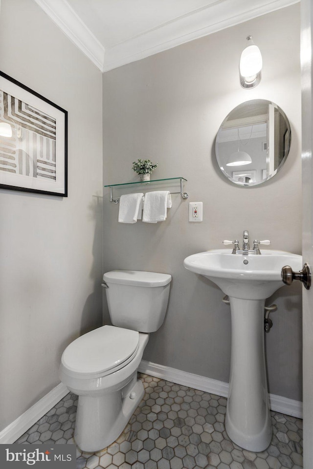 bathroom featuring crown molding, toilet, and tile patterned flooring