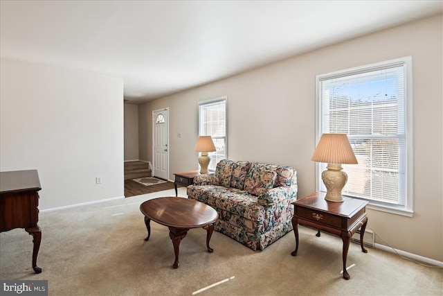 living area featuring carpet flooring and baseboards