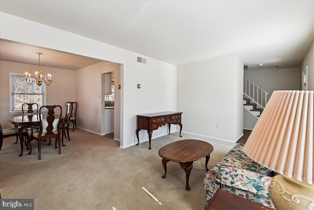 interior space with a chandelier, stairway, visible vents, and baseboards