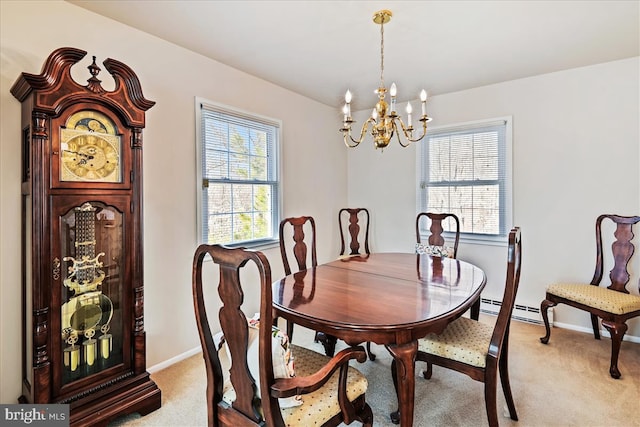 dining area with light carpet, a notable chandelier, and baseboards