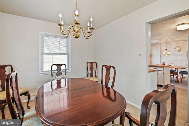 dining room featuring a chandelier, light tile patterned floors, and baseboards