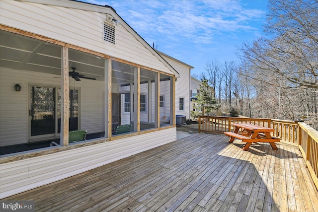 deck featuring a sunroom, ceiling fan, and cooling unit