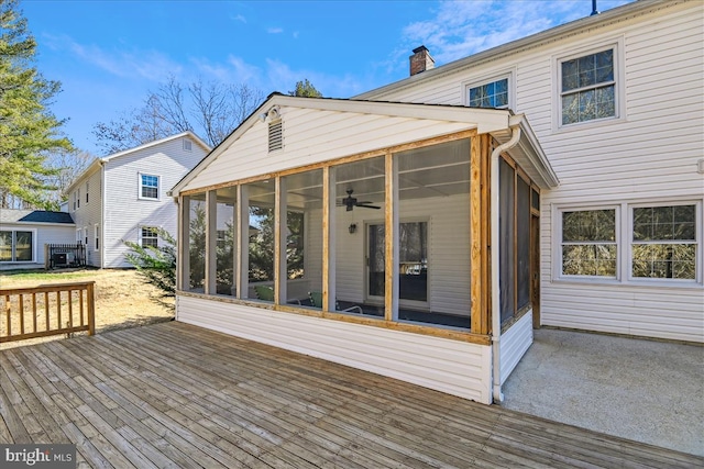 wooden deck with a sunroom