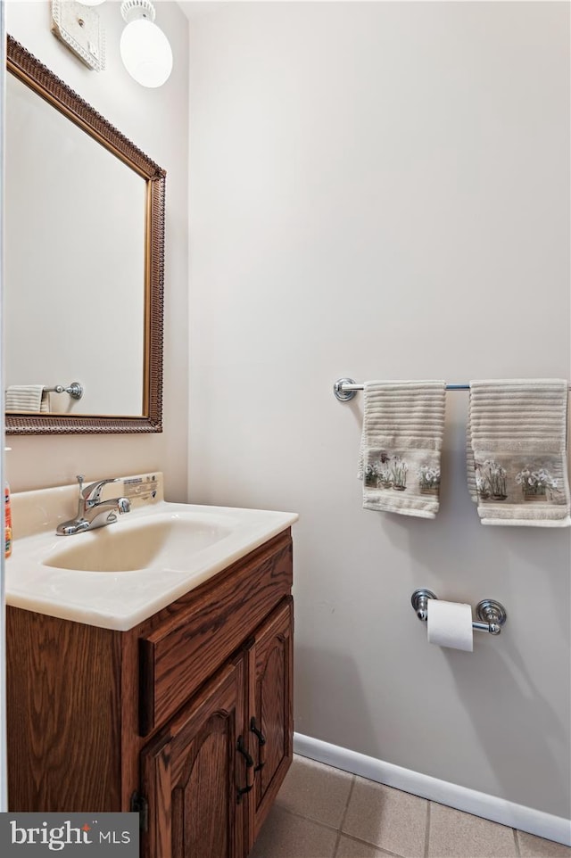 bathroom featuring vanity, baseboards, and tile patterned floors