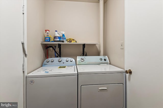 clothes washing area featuring laundry area and washer and dryer