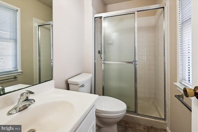 full bathroom featuring vanity, tile patterned flooring, a shower stall, and toilet