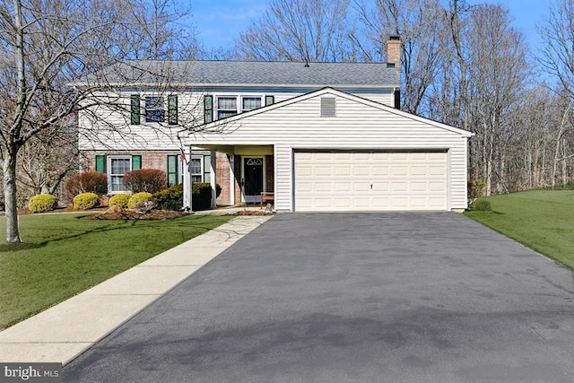 view of front of home with an attached garage, brick siding, driveway, a front lawn, and a chimney