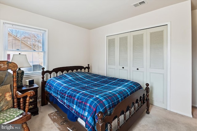 bedroom with carpet floors, a closet, and visible vents