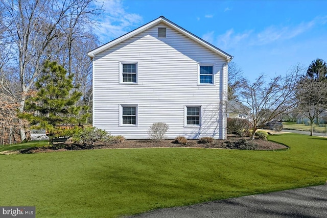 view of home's exterior featuring a lawn