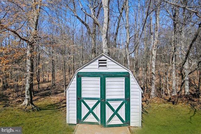 view of shed featuring a wooded view