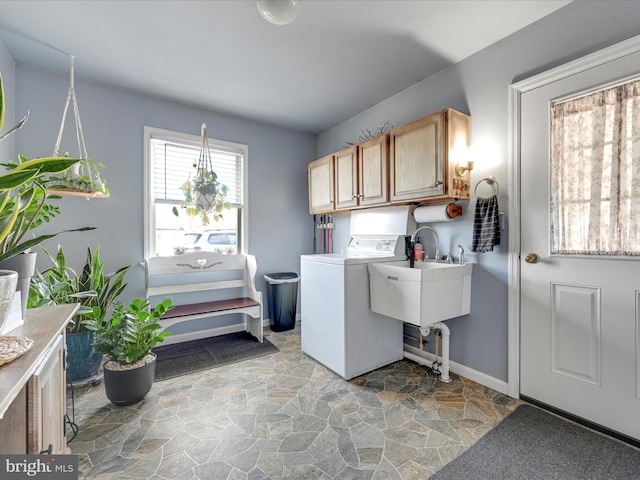 laundry room featuring sink, washer / clothes dryer, and cabinets