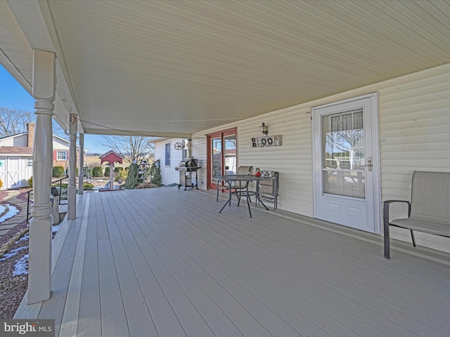 deck with a porch and a grill