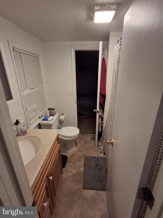 full bathroom with tile patterned flooring, vanity, and toilet