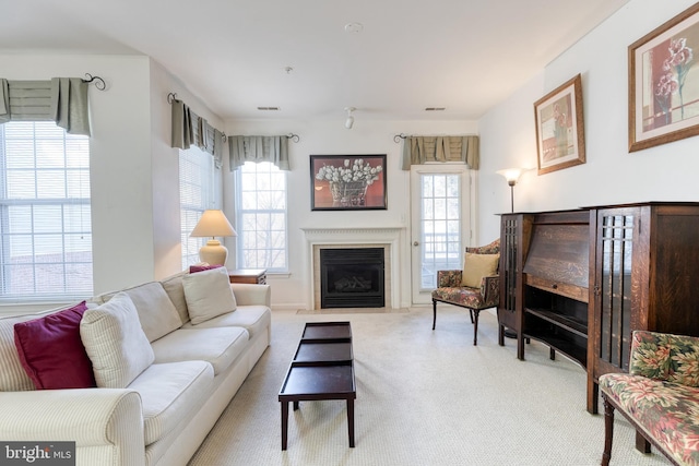 carpeted living room featuring plenty of natural light