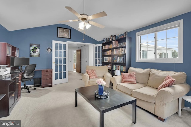 living room featuring vaulted ceiling, light carpet, ceiling fan, and french doors