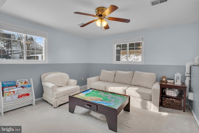 playroom featuring ceiling fan, light colored carpet, and plenty of natural light