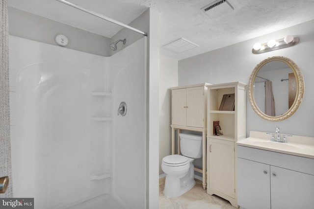 bathroom featuring walk in shower, vanity, toilet, and a textured ceiling