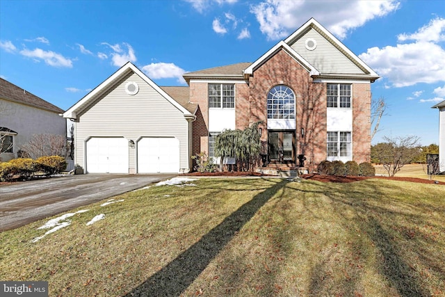 front facade featuring a garage and a front yard