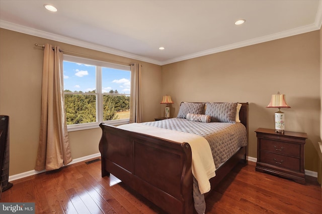 bedroom featuring dark hardwood / wood-style floors and crown molding