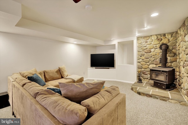 carpeted living room featuring a wood stove