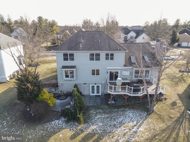 rear view of house with a deck, a lawn, and central air condition unit