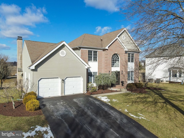 front facade featuring a front yard and a garage